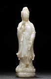 A WHITE JADE CARVED GUANYIN