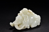 A WHITE JADE FIGURE OF BOY AND ELEPHANT