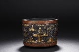 A PARCEL-GILT BRONZE 'FIGURES' TRIPOD CENSER
