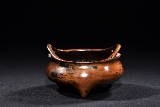 A BRONZE TRIPOD CENSER