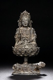 A BRONZE FIGURE OF MANJUSRI ON LOTUS THRONE