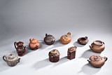 A SET OF 12 YIXING TEAPOTS
