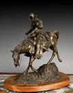 A CAST BRONZE COWBOY STATUE WITH THE TITLE'THE RIDE FOR LIFE'