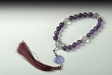 A STRAND OF BEADED AMETHYST PRAYER BEADS