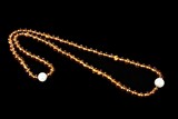 A STRAND OF 88 AMBER PRAYER BEADS
