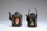 A PAIR OF TWO OCTAGONAL TIN TEAPOTS WITH MARK