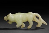 A CARVED JADE TIGER FIGURE
