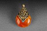 AN AMBER PENDANT