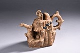 A CLAY CARVED TEAPOT
