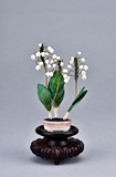 A WELL CARVED IVORY FLOWER PLANTER WITH WOOD STAND