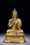 A GILT BRONZE FIGURE OF SEATED SHAKYAMUNI BUDDHA