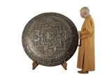 A RARE AND MASSIVE TIBETAN CARVED GILT MANDALA