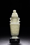 A WHITE JADE CARVED VASE W/ STAND