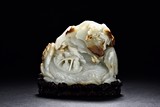 A WHITE JADE CARVED 'LANDSCAPE FIGURES' BOULDER