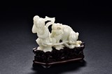 A WHITE JADE 'BOY AND BUDDHIST LION' GROUP