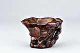 A HARDWOOD CARVED LIBATION CUP
