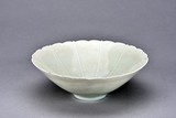 A WHITE GLAZED FLORIFORM BOWL 