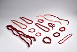 A GROUP OF CORAL OR CORAL-LIKE BEADED ORNAMENTS
