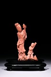 A CORAL CARVED FIGURAL GROUP