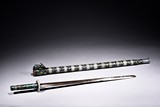 A SILVER AND ENAMELED JADE INSET SWORD