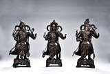 A GROUP OF THREE PARCEL-GILT BRONZE GUARDIAN KINGS