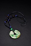 A CIRCULAR JADEITE DISC PENDANT