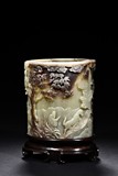 A GREENISH CELADON JADE BRUSH POT WITH SKIN