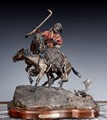A CAST BRONZE STATUE OF COWBOY AND HIS HORSES