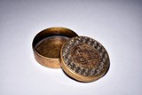 A CIRCULAR GILT-BRONZE BOX WITH COVER