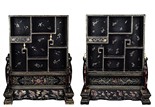 A PAIR OF GILT-PAINTED BLACK LACQUER TABLE SCREEN CABINETS