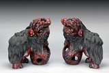 A PAIR OF RED LACQUER WOOD LIONS