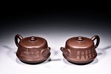 A PAIR OF YIXING 'LANDSCAPE' TEAPOTS