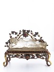 A CRYSTAL RECLINING BUDDHA ON GEM DECORATED GILT BRONZE STAND