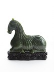 A SPINACH JADE CARVED RECUMBENT HORSE
