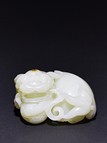 A WHITE JADE CARVED BUDDHIST LION 