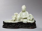 AN EXCEPTIONAL WHITE JADE FIGURE OF GUANYIN