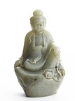 A CELADON JADE CARVED FIGURE OF GUANYIN