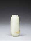 A WHITE JADE CARVING WITH SKIN