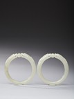 A PAIR OF WHITE JADE 'DRAGON' BANGLES