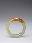 A YELLOW JADE CARVED BANGLE
