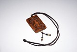 A HUANGYANGMU CARVED PENDANT