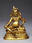 A GILT-BRONZE FIGURE OF JAMBHALA 