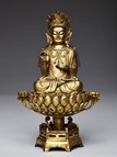 A GILT BRONZE FIGURE OF GUANYIN UPON LOTUS 