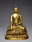 A LARGE GILT-BRONZE FIGURE OF SEATED SHAKYAMUNI