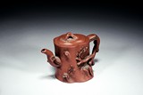 A YIXING ZISHA 'PRUNUS TRUNK' TEAPOT