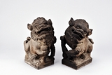 A PAIR OF STONE CARVED BUDDHIST LIONS