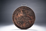 A WOOD CARVED CIRCULAR PANEL