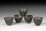 A SET OF FIVE COCONUT CUPS