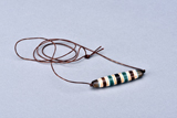 A VERY RARE FOUR-COLORED DZI BEAD