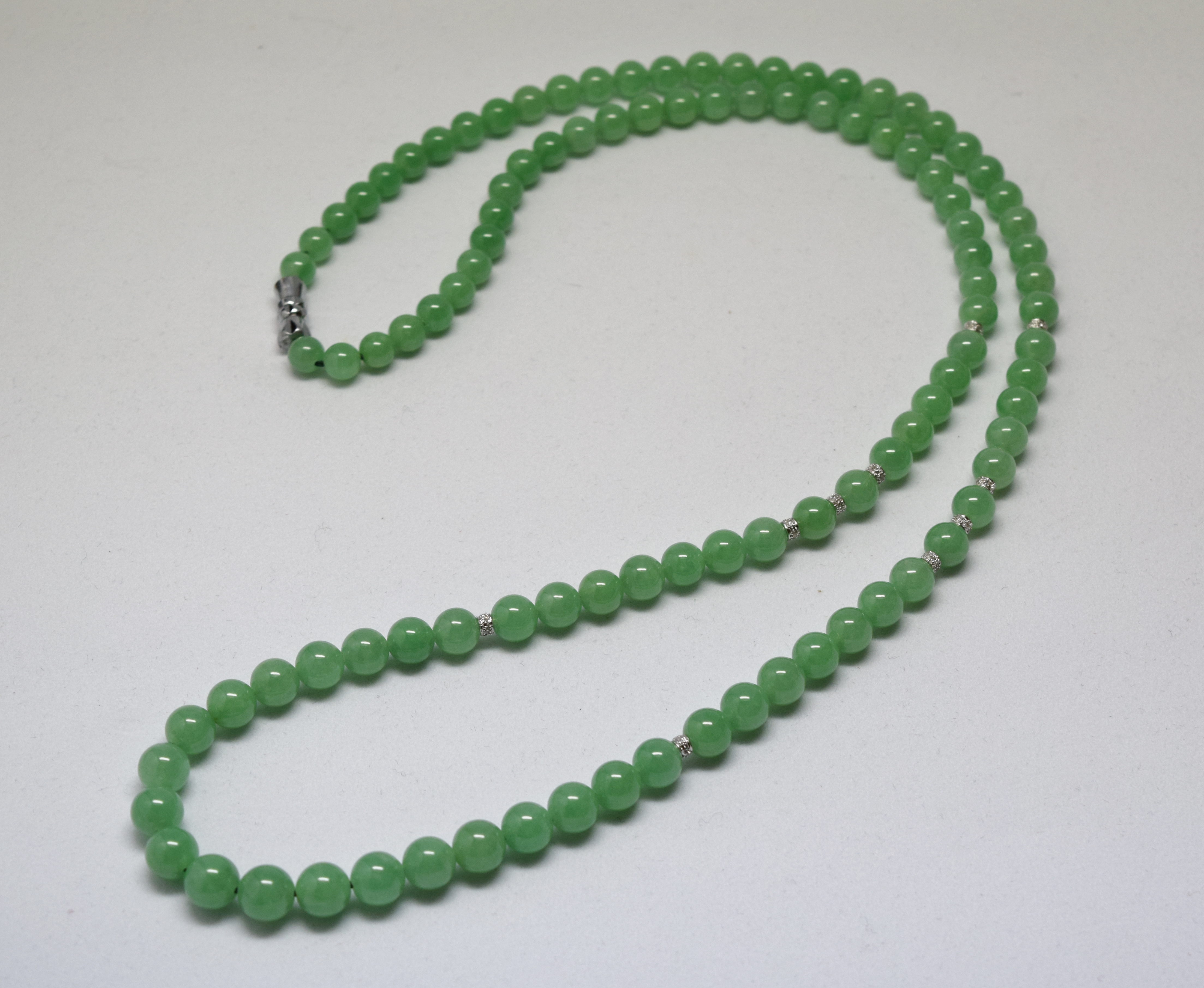 A LONG JADEITE BEAD NECKLACE